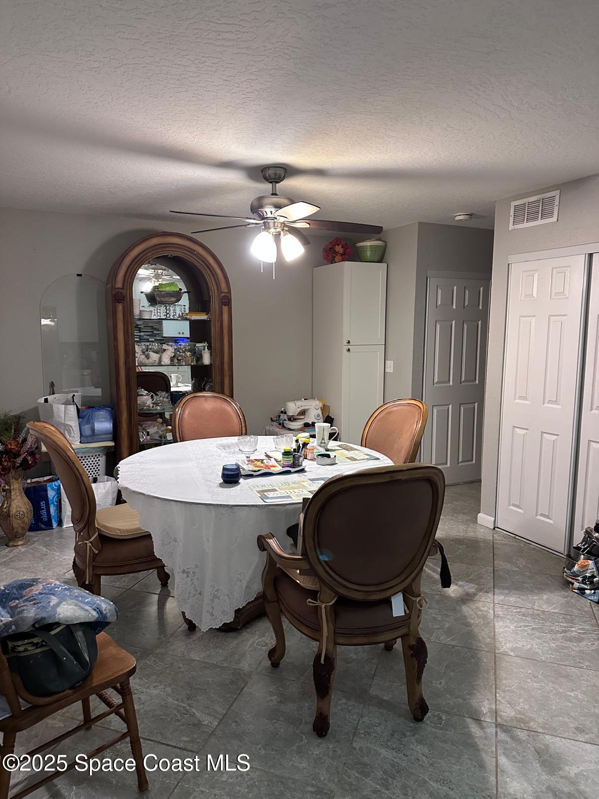 2014 Manor Drive Northeast Palm Bay, FL 32905 - Photo 8 of 15 a living room with a table chairs and a dining table with wooden floor