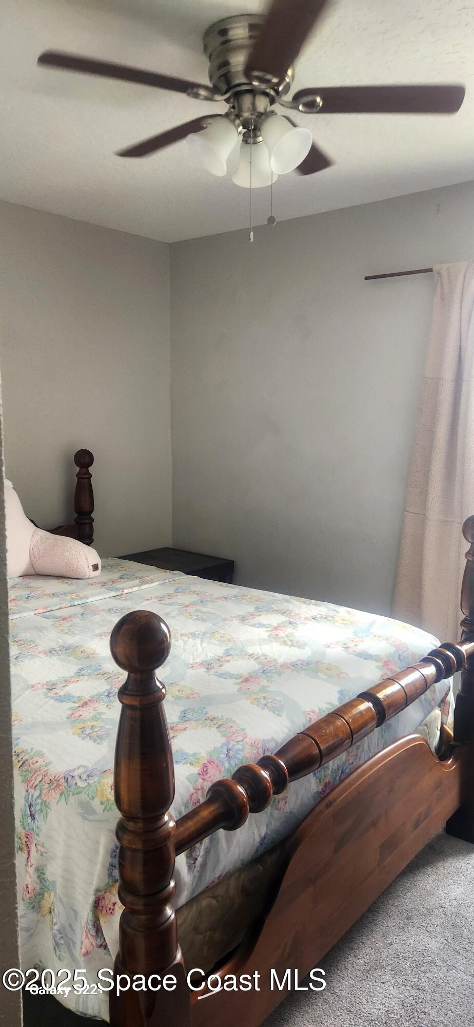 2014 Manor Drive Northeast Palm Bay, FL 32905 - Photo 9 of 15 a bed sitting in a bedroom next to a window