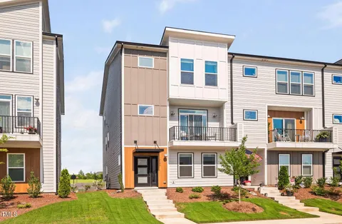 a front view of a residential apartment building with a yard