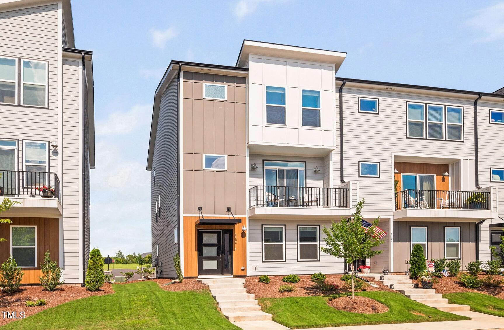 a front view of a residential apartment building with a yard