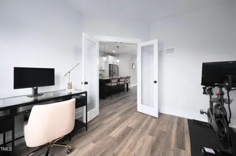 a view of a workspace with furniture and wooden floor