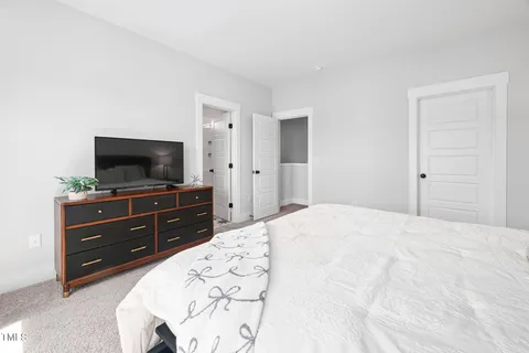 a bed room with a bed and a television