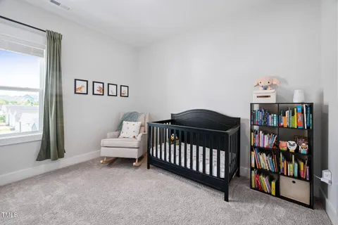 a bedroom with a bed and a book shelf