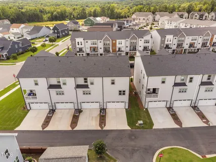 an aerial view of multiple houses with a yard