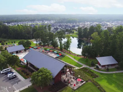 an aerial view of a house with a garden and lake view