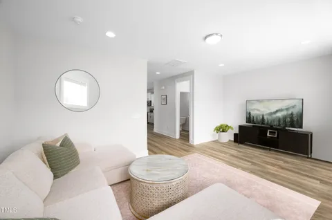 a living room with furniture and a rug