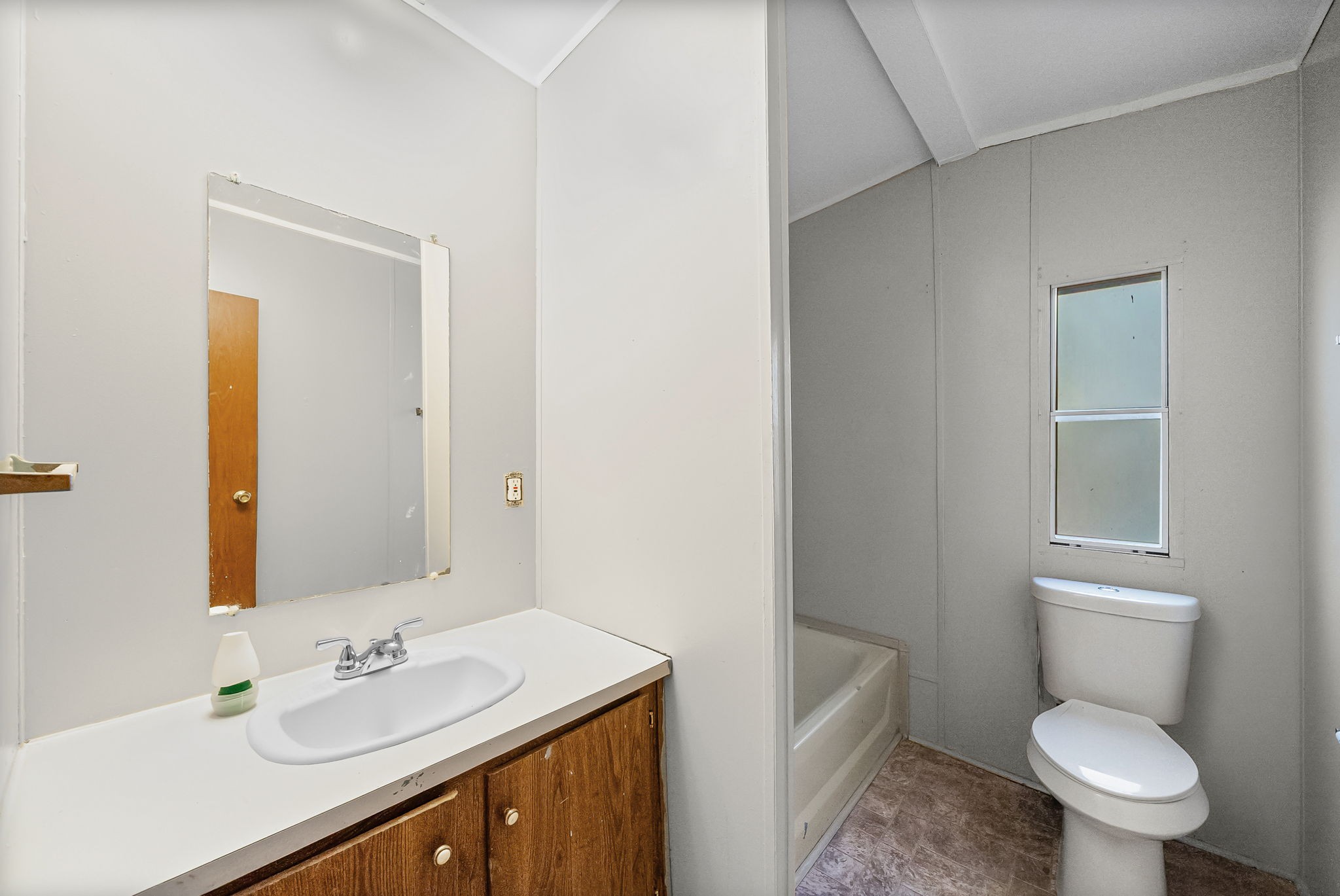 1105 Valley View Road Ashland City, TN 37015 - Photo 18 of 28 a bathroom with a granite countertop toilet a sink and a mirror