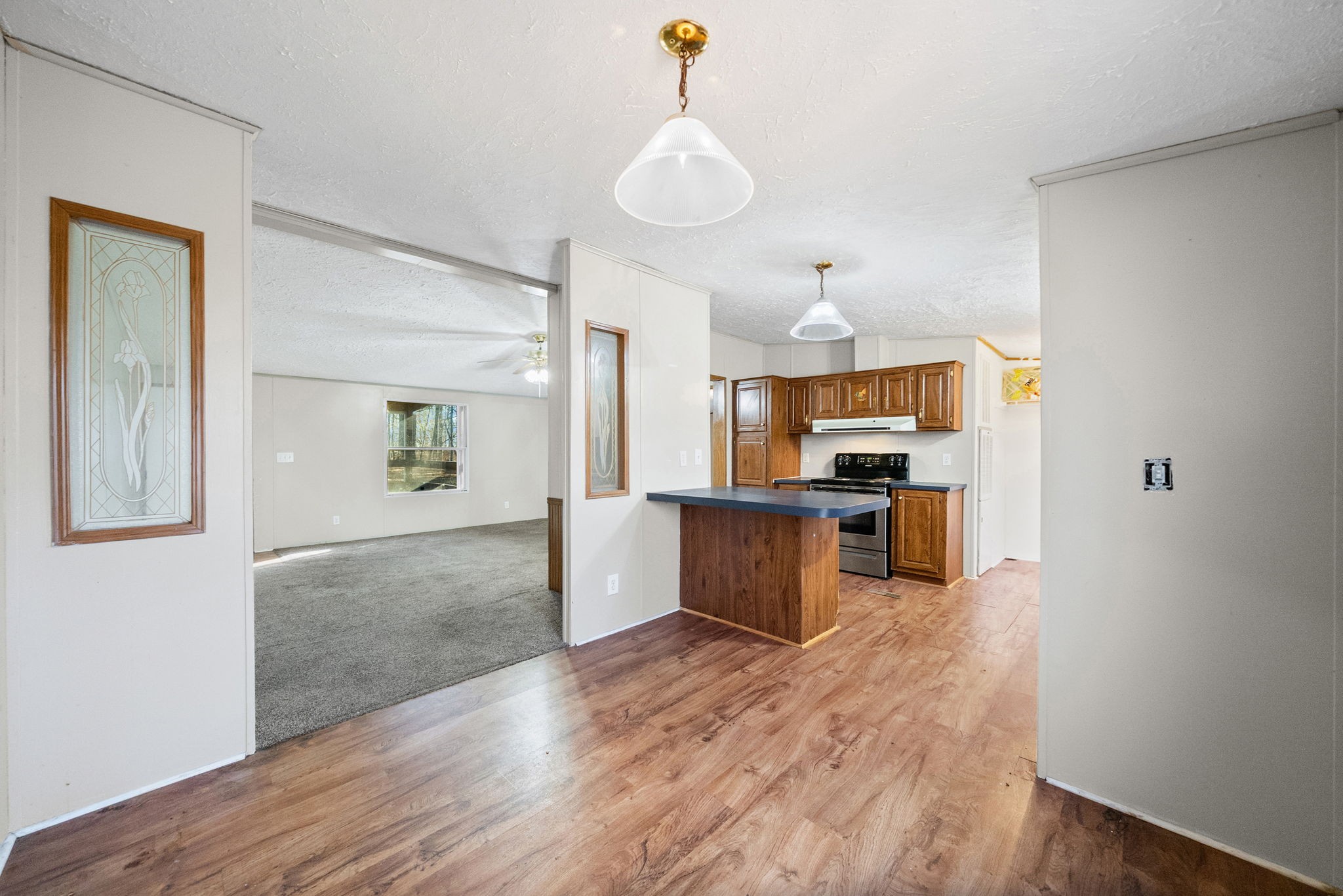 1105 Valley View Road Ashland City, TN 37015 - Photo 10 of 28 a view of a kitchen and an empty room with wooden floor