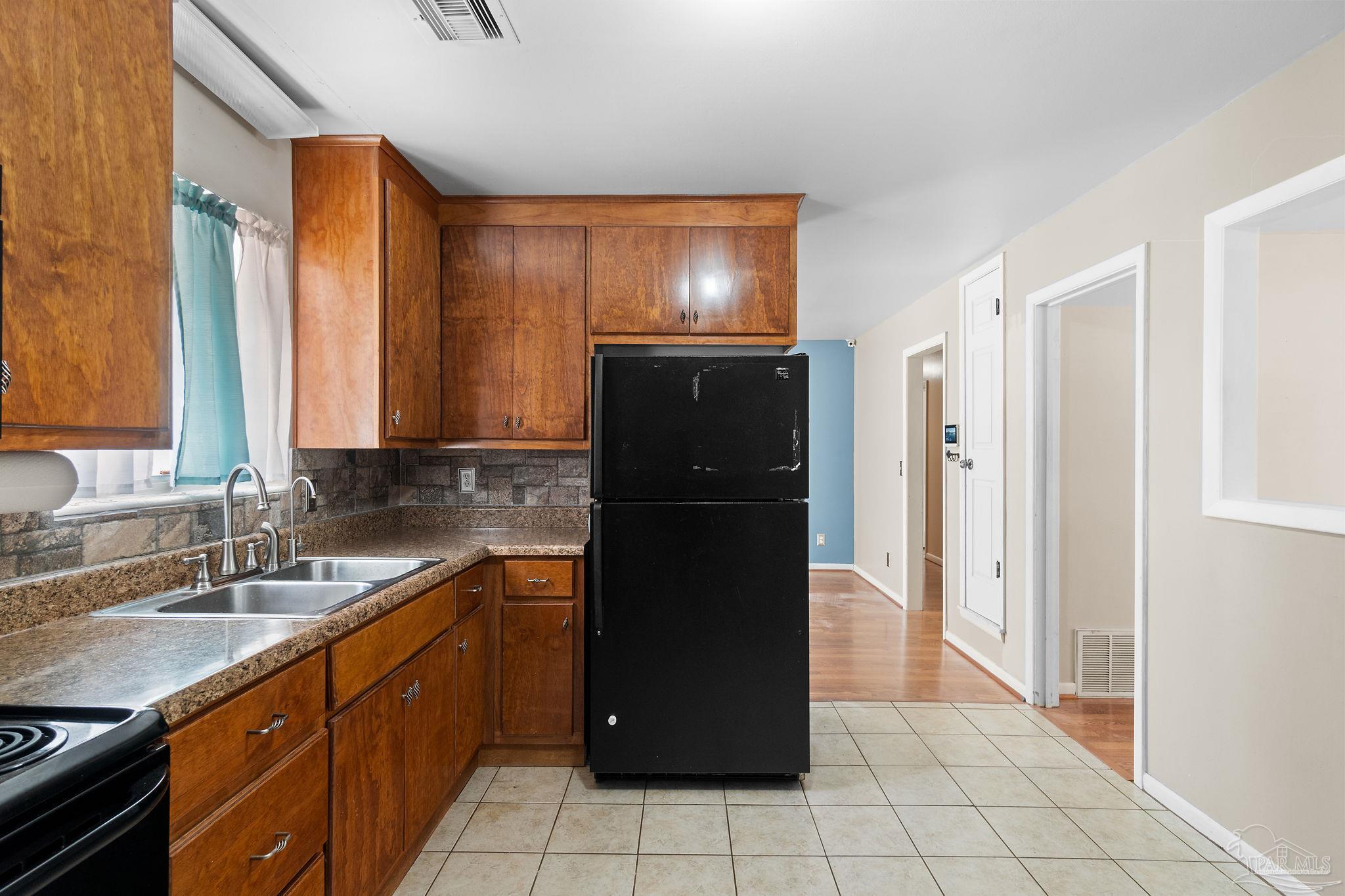 2969 Sky Crest Drive Pensacola, FL 32514 - Photo 11 of 50 a kitchen with a refrigerator and a sink