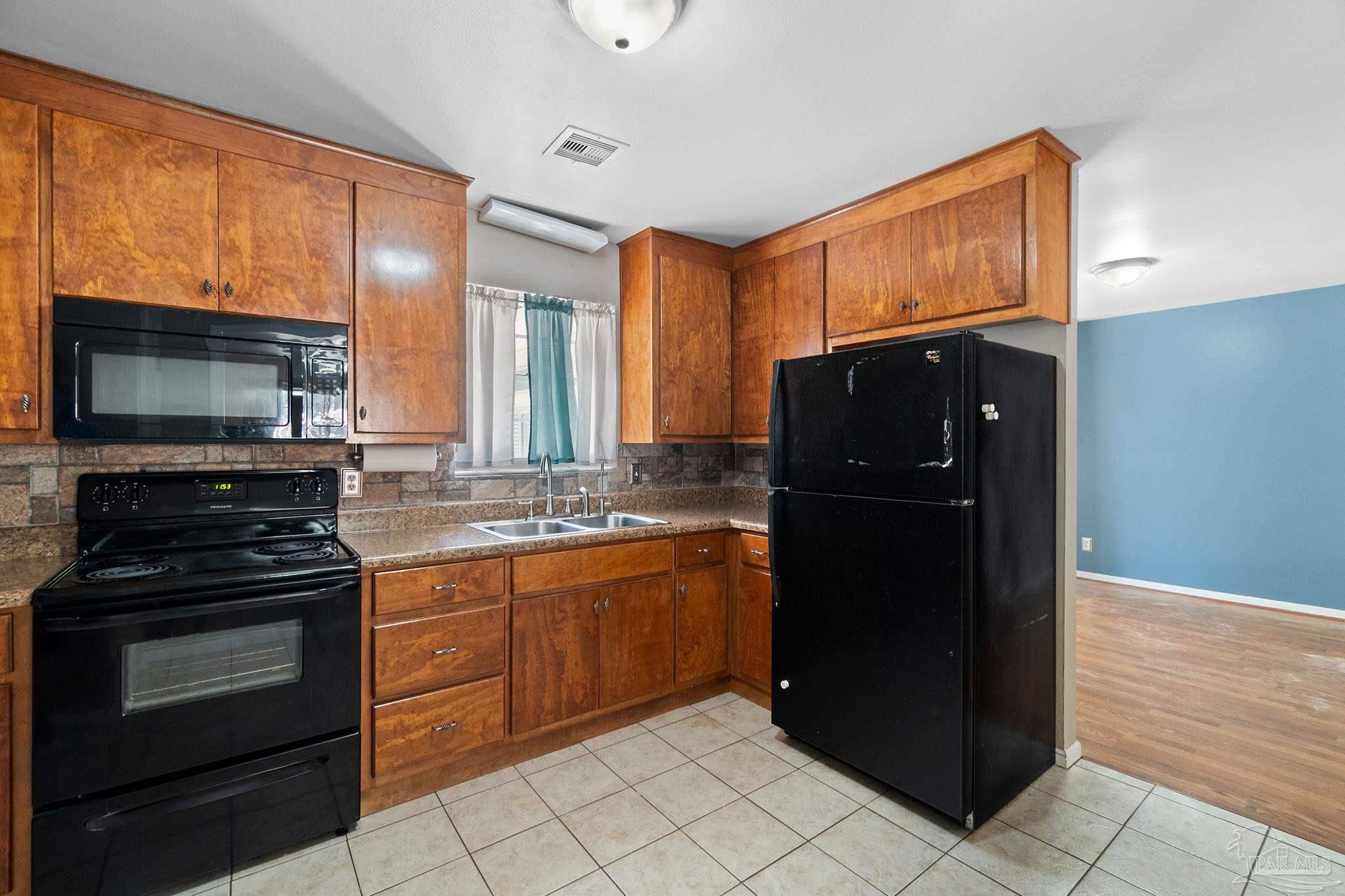 2969 Sky Crest Drive Pensacola, FL 32514 - Photo 12 of 50 a kitchen with stainless steel appliances granite countertop a refrigerator and a stove top oven