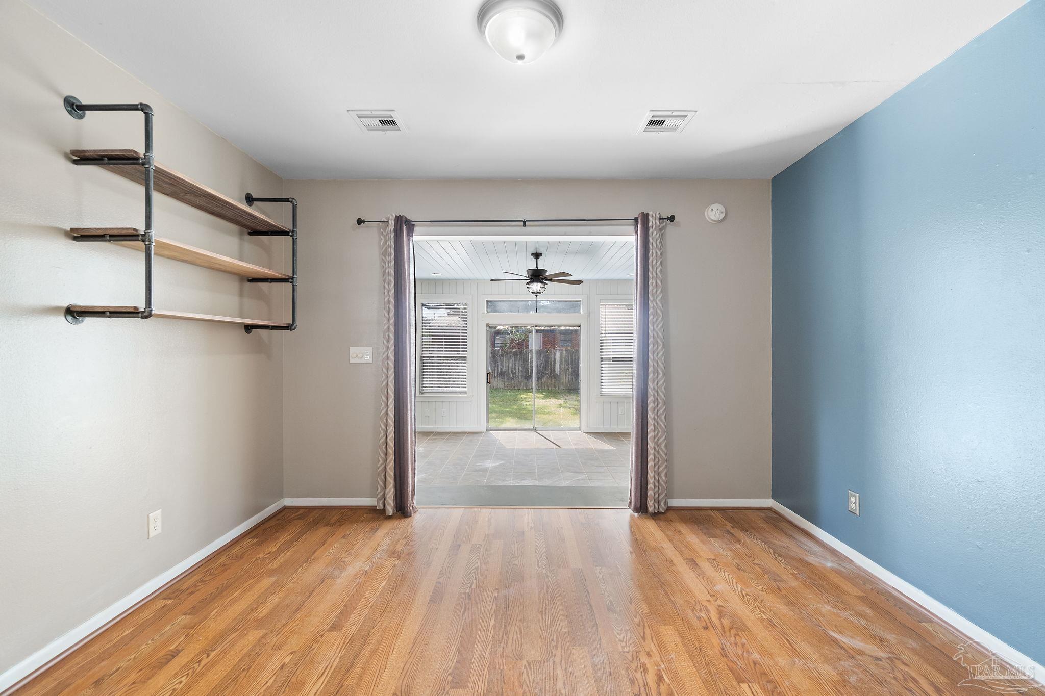 2969 Sky Crest Drive Pensacola, FL 32514 - Photo 14 of 50 a view of an empty room with wooden floor and a window