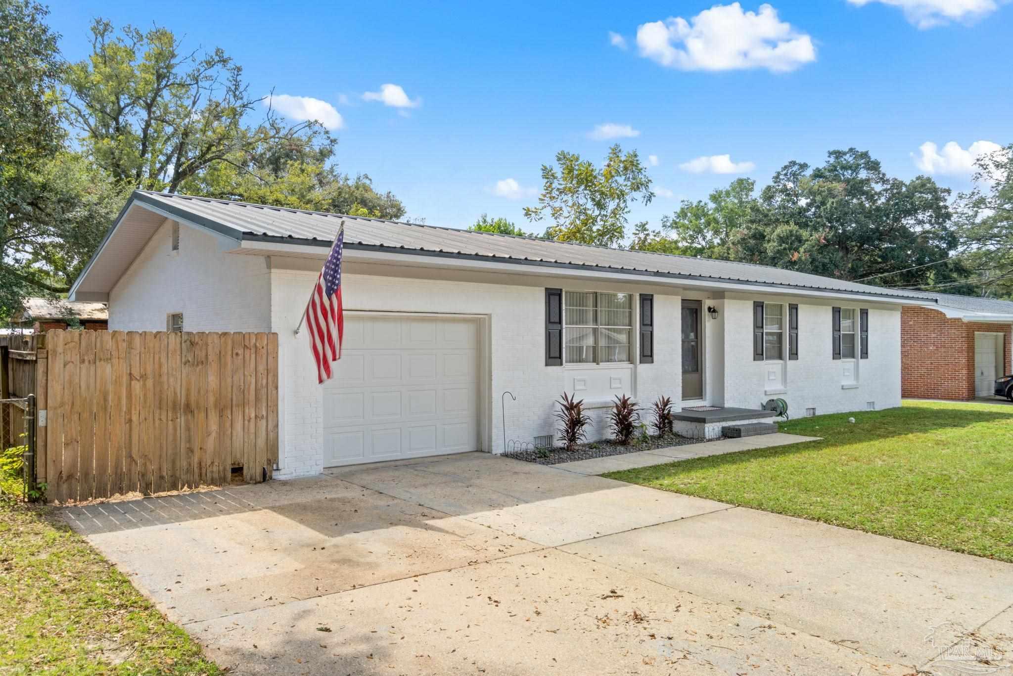 2969 Sky Crest Drive Pensacola, FL 32514 - Photo 2 of 50 a front view of a house with a garden and trees