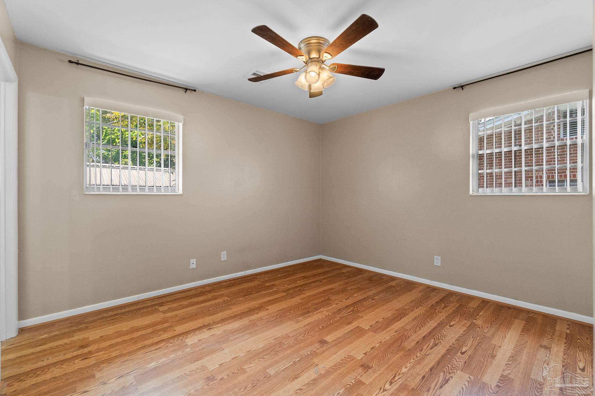 2969 Sky Crest Drive Pensacola, FL 32514 - Photo 22 of 50 wooden floor in an empty room with a window