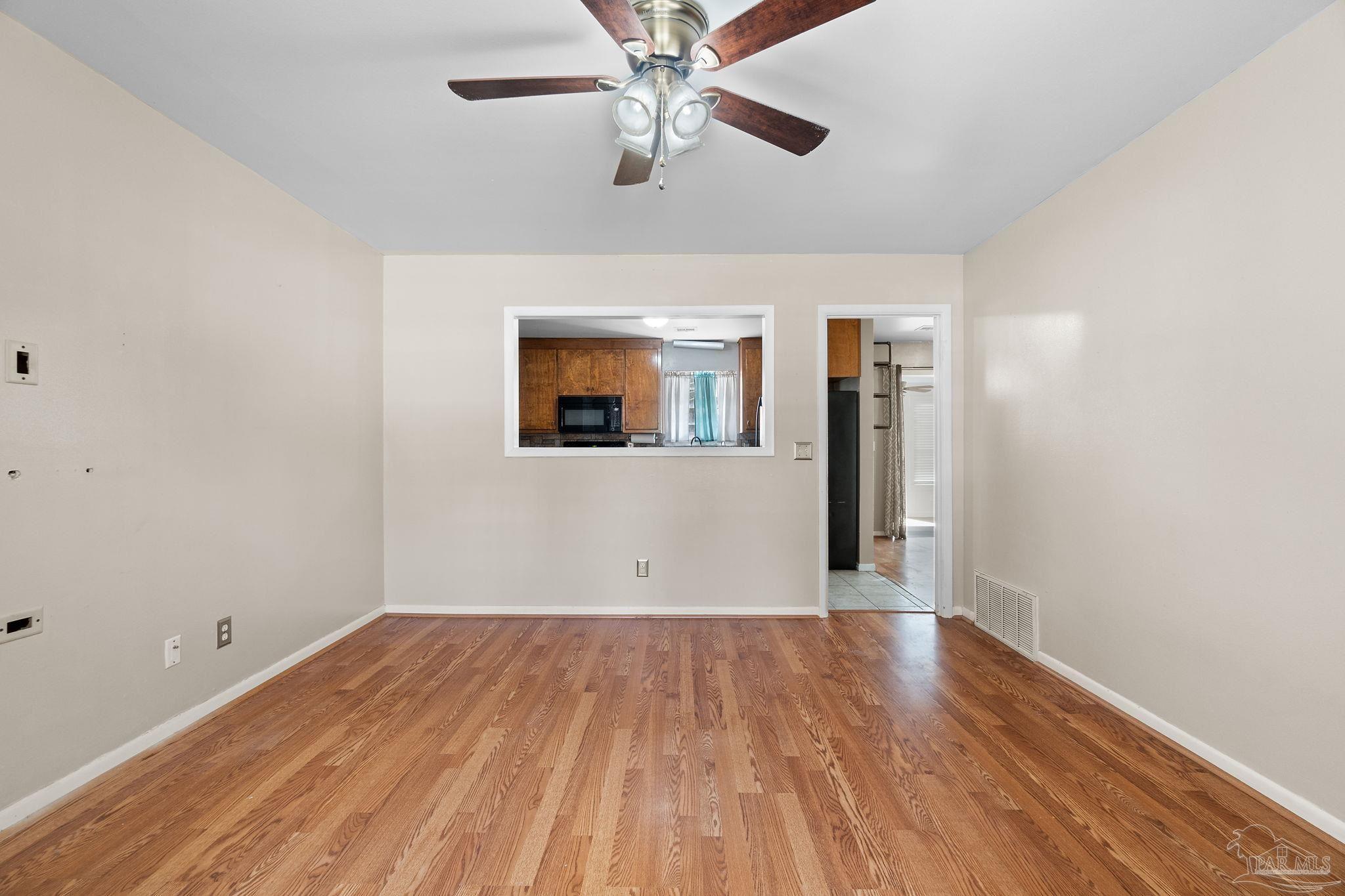 2969 Sky Crest Drive Pensacola, FL 32514 - Photo 7 of 50 wooden floor in an empty room with a window