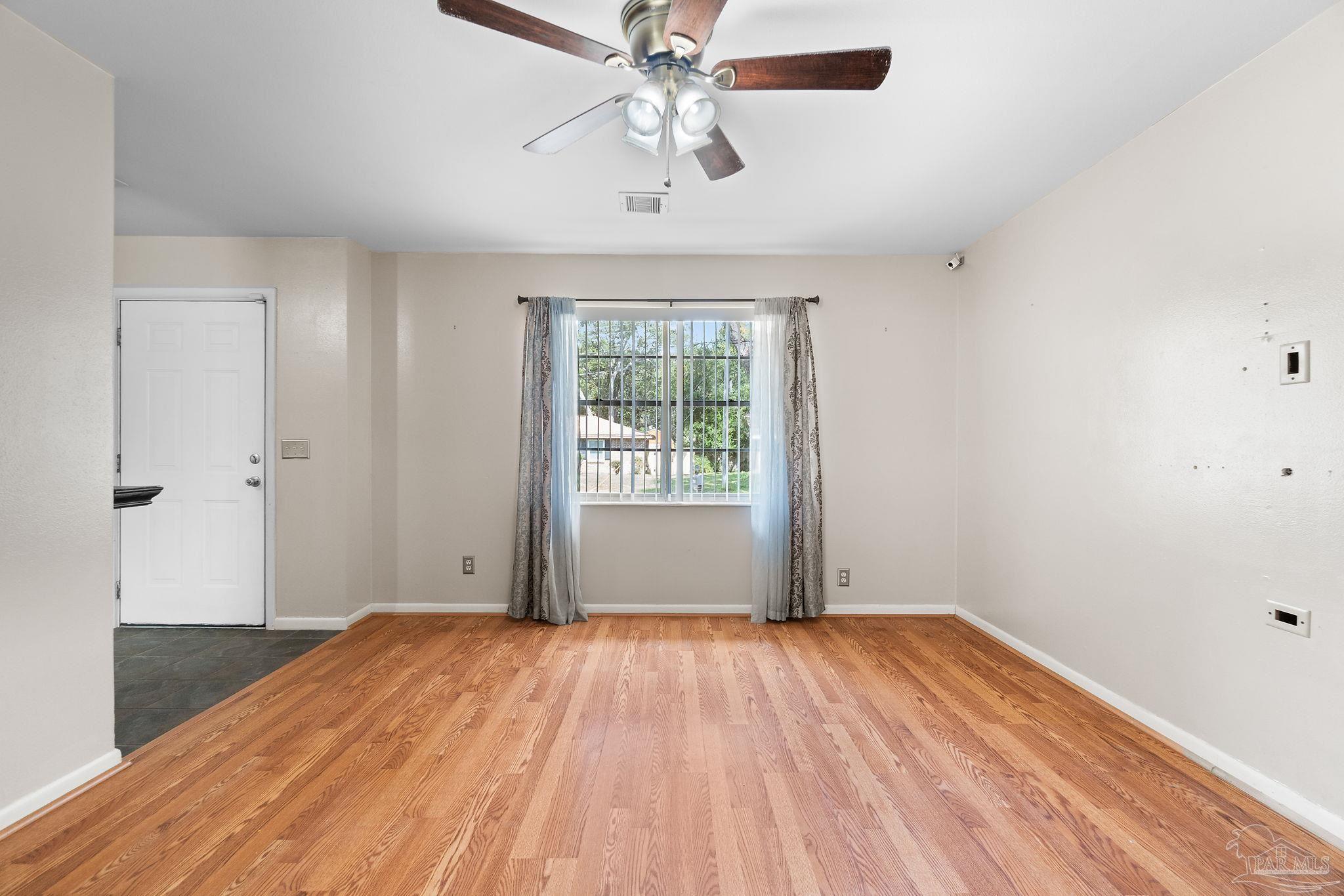 2969 Sky Crest Drive Pensacola, FL 32514 - Photo 9 of 50 wooden floor in an empty room with a window