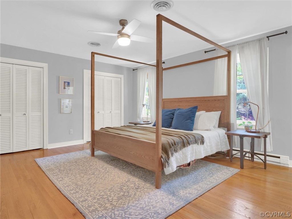 3933 Cresthill Road Chester, VA 23831 - Photo 40 of 49 a spacious bedroom with a bed and a table with wooden floor