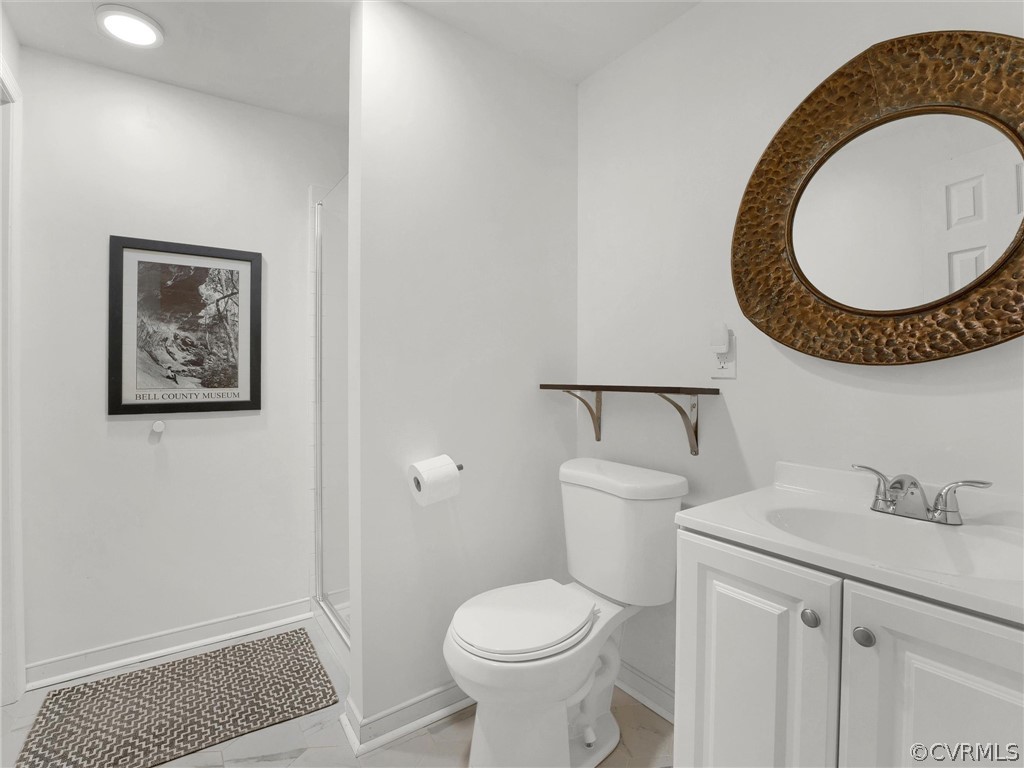 3933 Cresthill Road Chester, VA 23831 - Photo 47 of 49 a bathroom with a toilet a sink and a mirror