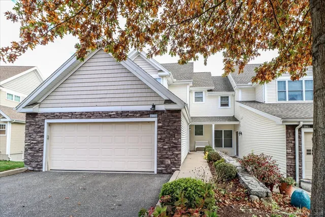 a front view of house with yard and trees around