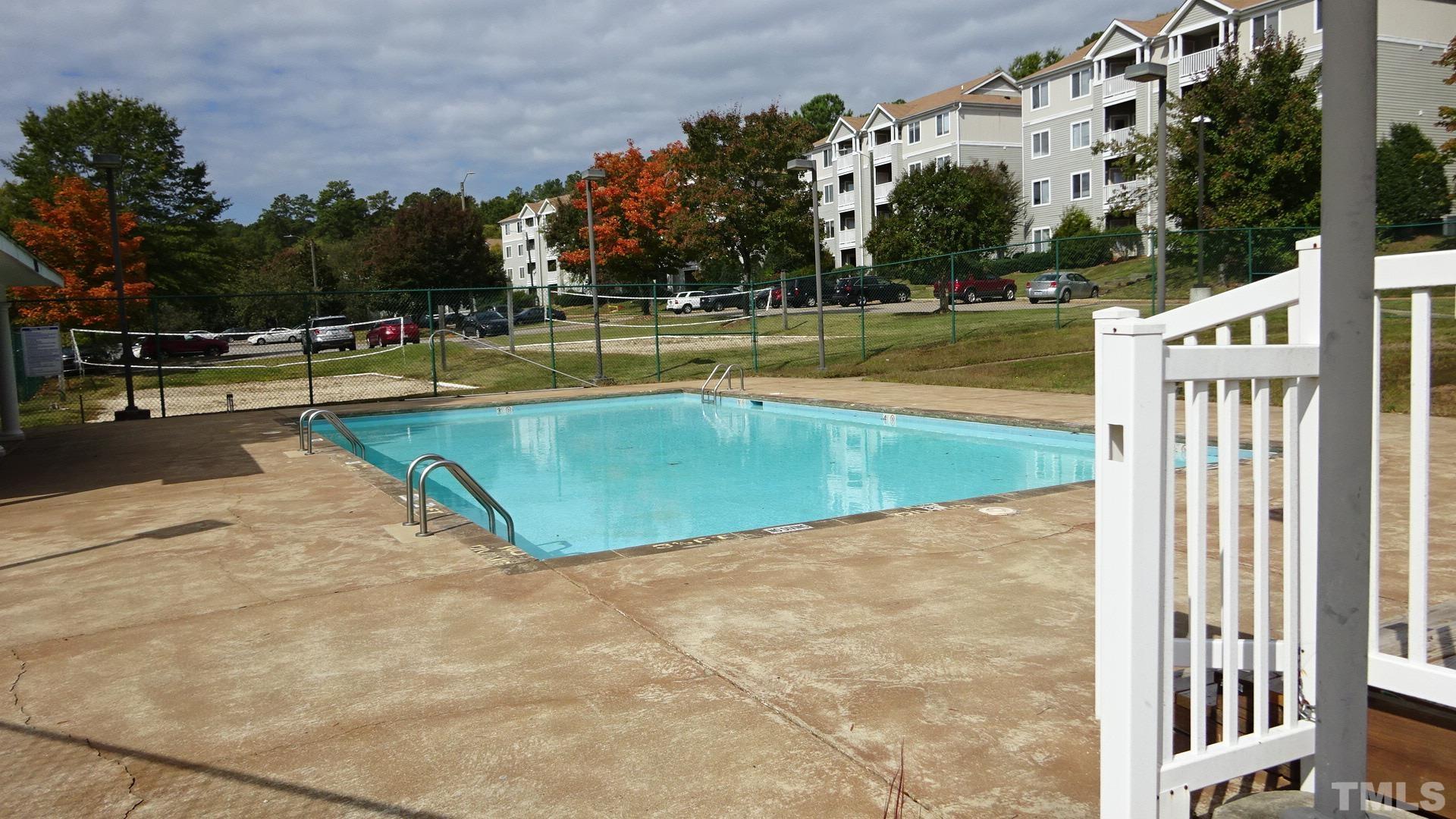 1441 Collegiate Circle, Unit 304 Raleigh, NC 27606 - Photo 17 of 24 a view of a swimming pool with an outdoor space and seating area
