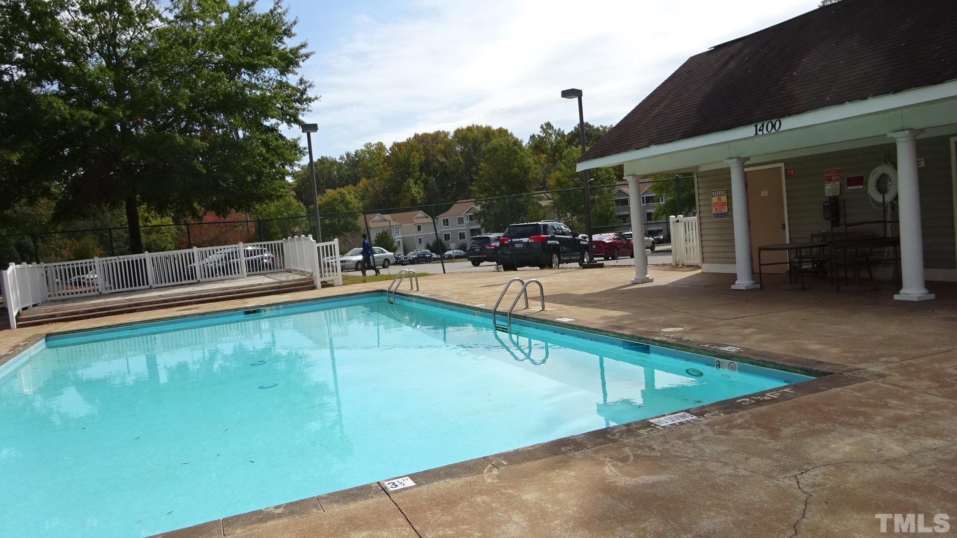 1441 Collegiate Circle, Unit 304 Raleigh, NC 27606 - Photo 18 of 24 a view of a patio with swimming pool table and chairs