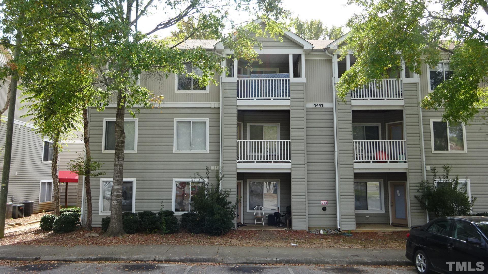 1441 Collegiate Circle, Unit 304 Raleigh, NC 27606 - Photo 2 of 24 a front view of a house with plants