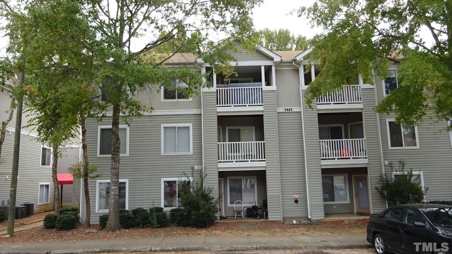 1441 Collegiate Circle, Unit 304 Raleigh, NC 27606 - Photo 23 of 24 a front view of a house with a tree