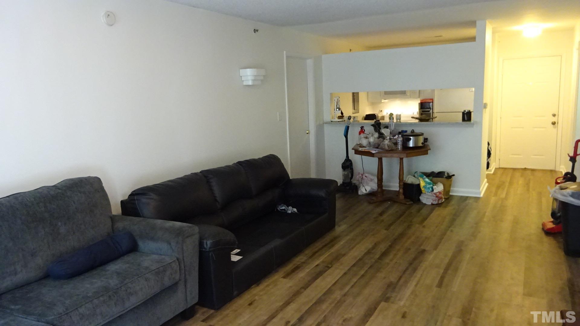 1441 Collegiate Circle, Unit 304 Raleigh, NC 27606 - Photo 5 of 24 a living room with furniture and a wooden floor