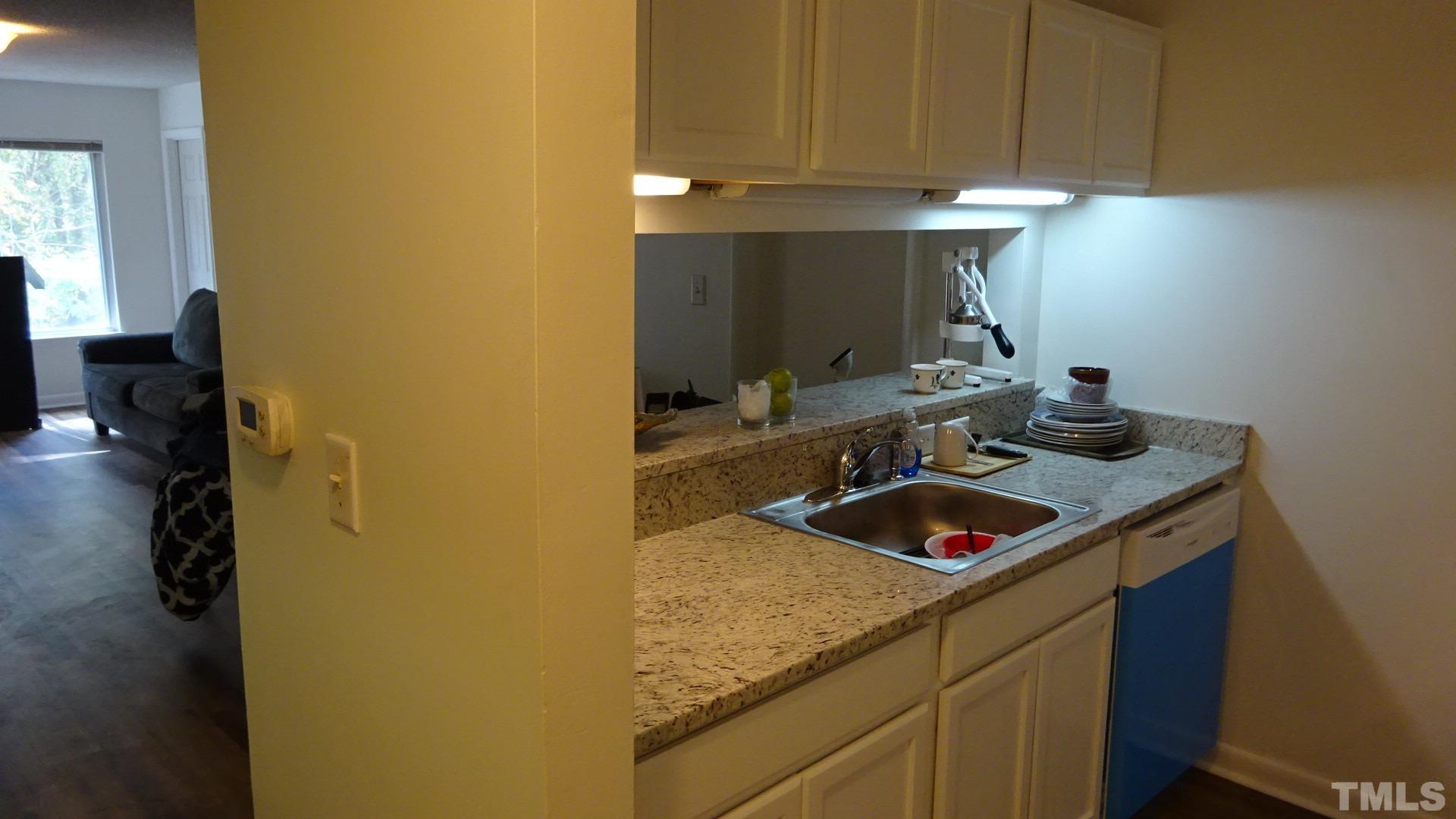 1441 Collegiate Circle, Unit 304 Raleigh, NC 27606 - Photo 7 of 24 a bathroom with a sink and a mirror