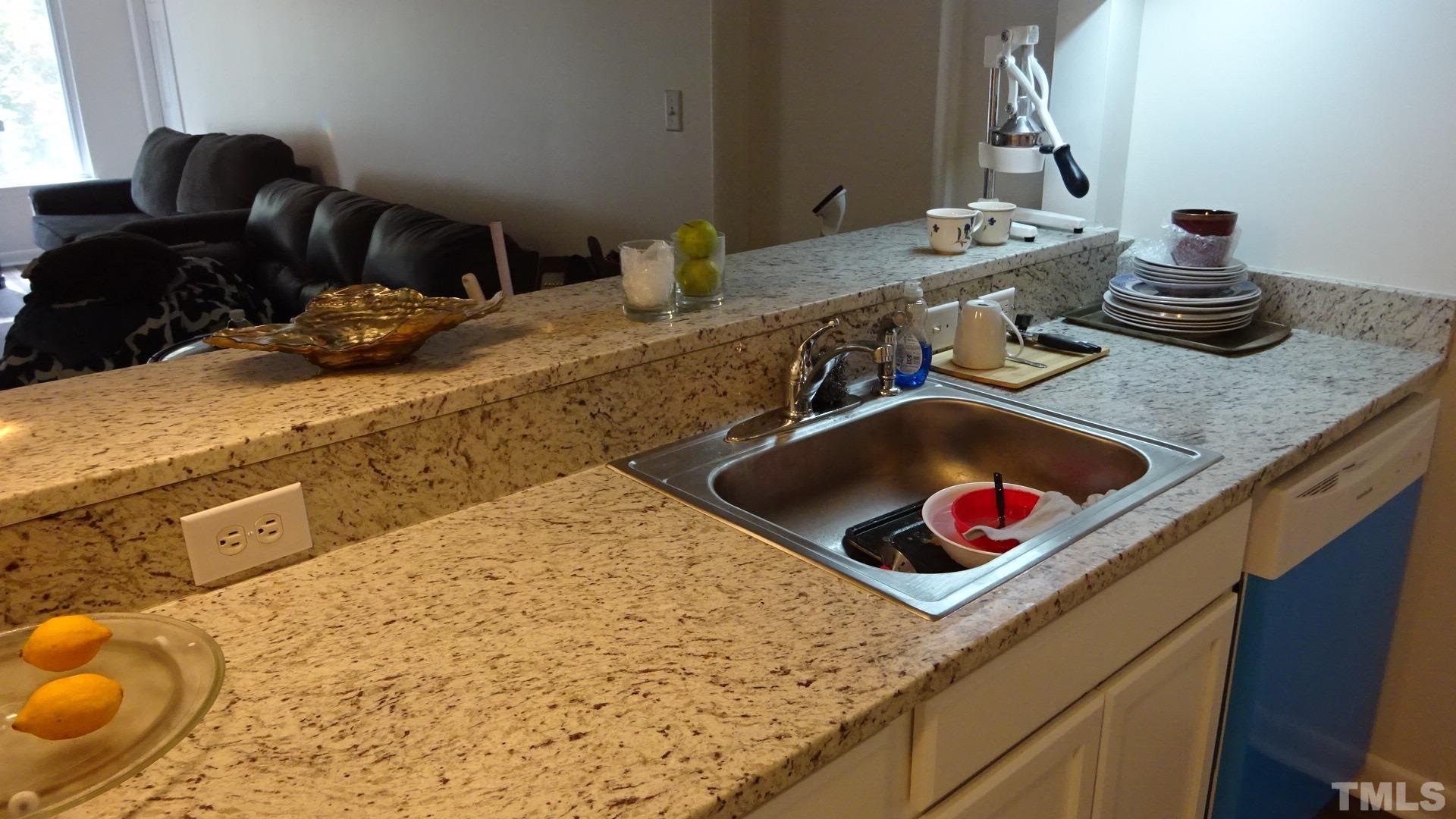 1441 Collegiate Circle, Unit 304 Raleigh, NC 27606 - Photo 10 of 24 a bathroom with a granite countertop sink and a mirror