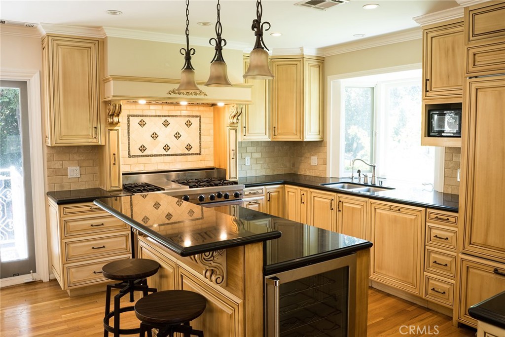 720 Heatherside Road Pasadena, CA 91105 - Photo 14 of 23 a kitchen with stainless steel appliances granite countertop a sink a stove and a refrigerator