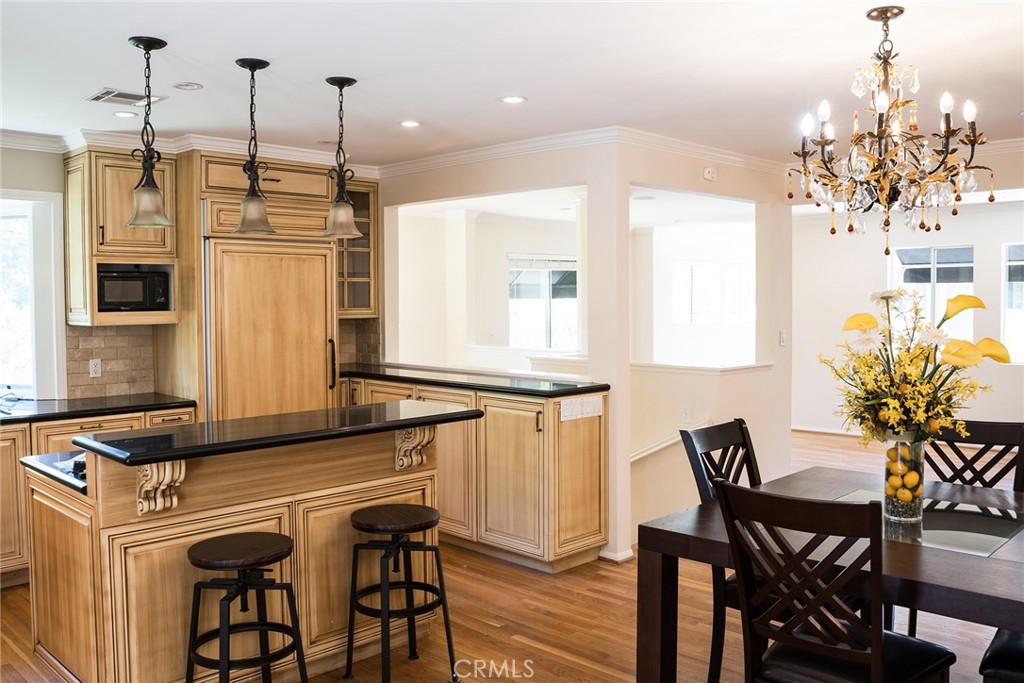 720 Heatherside Road Pasadena, CA 91105 - Photo 17 of 23 a kitchen with stainless steel appliances granite countertop a dining table chairs and chandelier