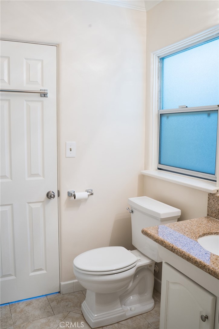 720 Heatherside Road Pasadena, CA 91105 - Photo 19 of 23 a white toilet sitting next to a bathroom sink