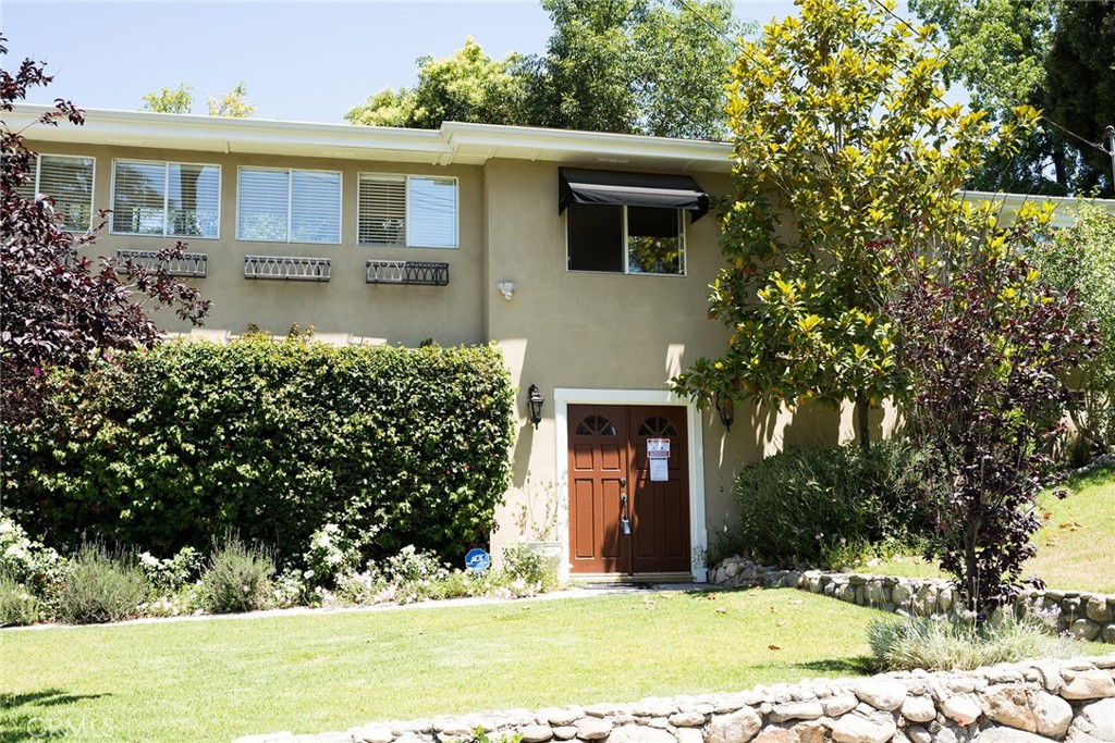 720 Heatherside Road Pasadena, CA 91105 - Photo 2 of 23 a front view of a house with a yard