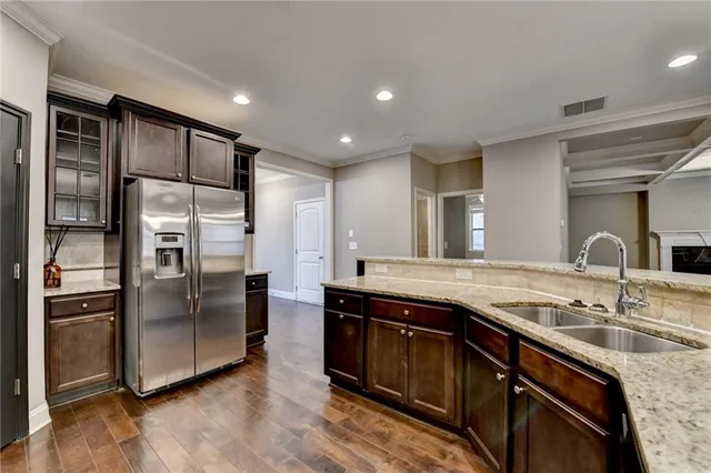 a kitchen with granite countertop a sink and cabinets