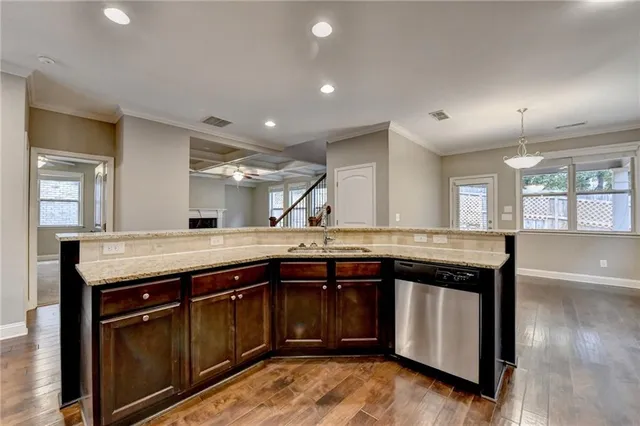 a kitchen with stainless steel appliances granite countertop refrigerator sink and cabinets