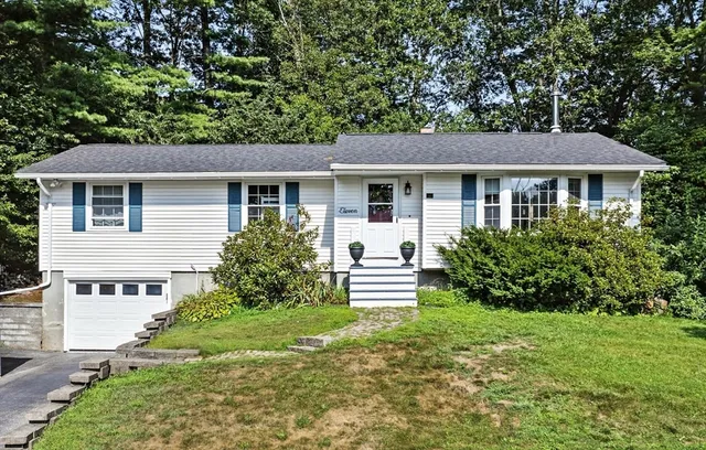 a front view of house with yard and green space