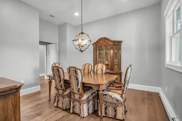 a view of a dining room with furniture window and wooden floor