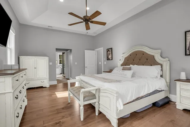 a bedroom with a bed and a chandelier