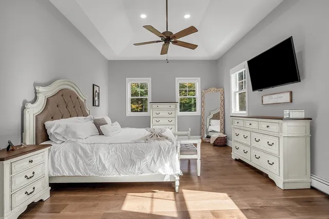 a bedroom with furniture and flat screen tv