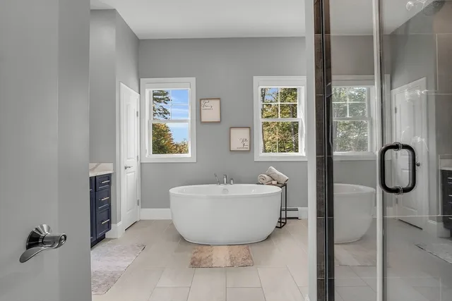 a bathroom with a bathtub and shower