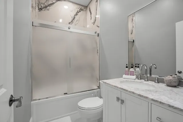 a kitchen with granite countertop white cabinets and appliances