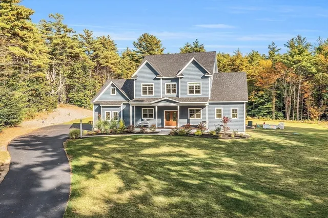 a view of a house with a yard and garage