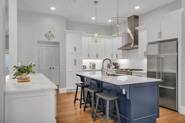 a kitchen with a table chairs sink and cabinets