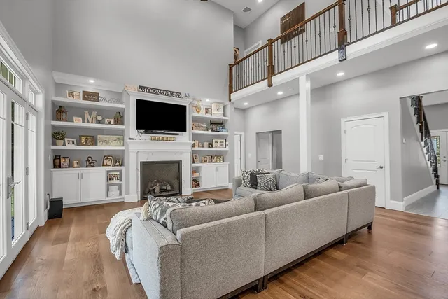 a living room with furniture a flat screen tv and a fireplace