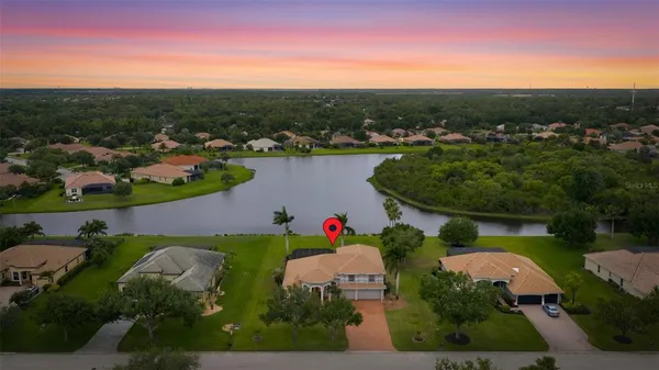an aerial view of a houses with outdoor space and lake view