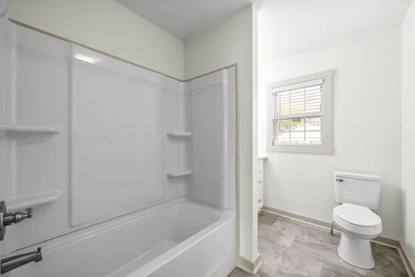 a bathroom with a toilet and a bathtub