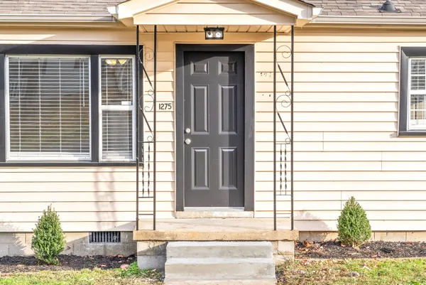 a front view of a house with a yard and outdoor seating