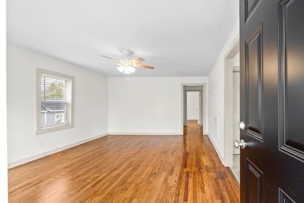 a view of a livingroom with wooden floor and a window