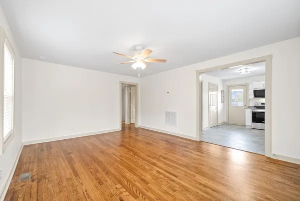 wooden floor in an empty room with a window