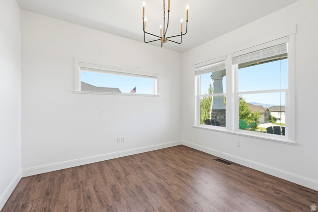 338 Windy Rdg Drive Smithfield, UT 84335 - Photo 8 of 63 Spacious room featuring wood-finish flooring, white baseboards, and white walls